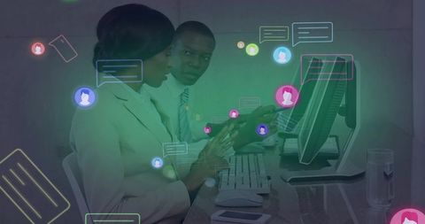 Colleagues collaborating at desktop with chat bubble overlays for digital teamwork