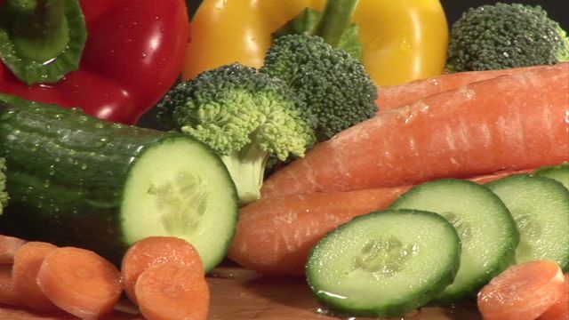 Vibrant assortment of fresh vegetables including carrots, cucumbers, broccoli, and yellow bell pepper. Highlighting natural produce and healthy eating with colorful, crisp textures. Ideal for use in materials focused on nutrition, farm-to-table concepts, or recipes promoting wholesome diets.