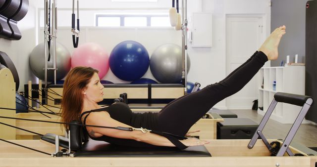 Woman Exercising with Pilates Reformer in Fitness Studio - Download Free Stock Images Pikwizard.com