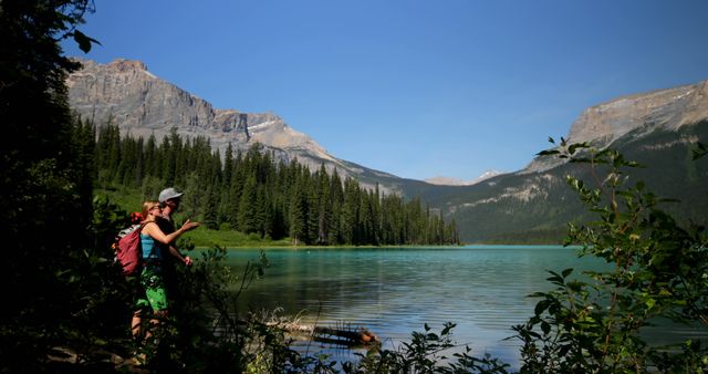 Hikers Explores Calm Lake in Mountain Landscape - Download Free Stock Images Pikwizard.com