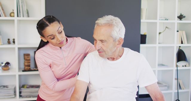 Caregiver supports elderly man at home, showing compassion and care. Ideal for use in health care, home care services, elderly support campaigns, nursing, and family support materials.