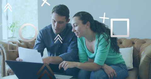 Couple managing finances online at home