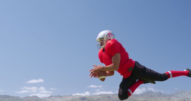 Football Player Catching Pass in Midair Under Clear Sky - Download Free Stock Images Pikwizard.com