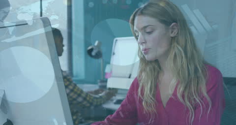 Businesswoman Analyzing Data on Computer in Modern Office