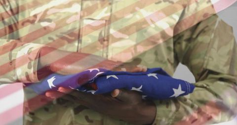 Service member holding american flag showing patriotism and valor