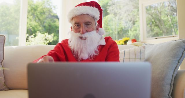 Senior Man in Santa Suit Using Laptop at Home - Download Free Stock Images Pikwizard.com