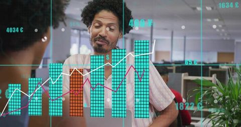 Leaning man discussing data analytics with turquoise bar charts and graphs in modern open office