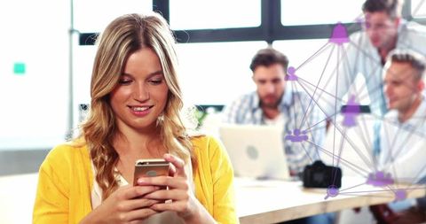 Woman Engaging with Smartphone in Modern Office Environment