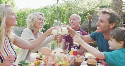 Happy Family Enjoying Outdoor Meal Together in Lush Garden - Download Free Stock Images Pikwizard.com