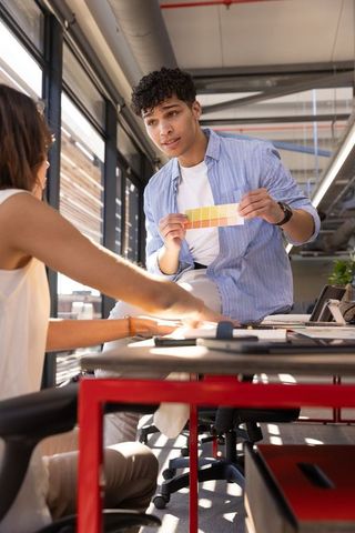 Diverse team collaborating with color swatches in modern office