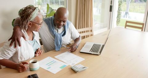 Happy Senior Couple Managing Finances at Home