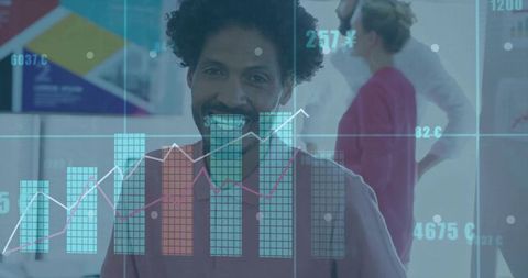 Smiling businessman standing behind digital data overlay with charts and teamwork