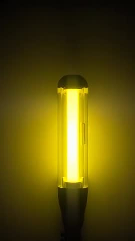 Vertical video centering on glowing inspection LED lamp, camera zooming revealing core