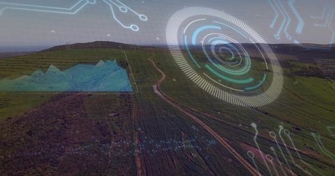 Aerial farmland showing hud overlays for precision agriculture data and winding dirt road