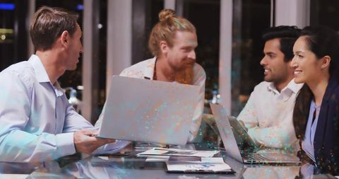 Team Collaboration in Modern Office at Night with Technology