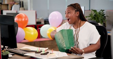 Woman Celebrating Office Birthday with Smile and Balloons