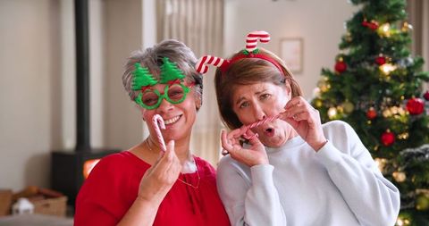Senior Women Celebrating Christmas with Candy Canes and Festive Accessories