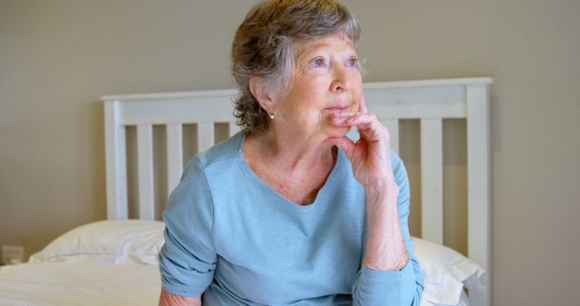 Contemplative Senior Woman Sitting on Bed at Home - Download Free Stock Images Pikwizard.com