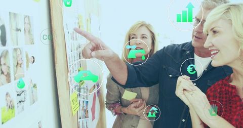 Team collaborating around moodboard with analytics icons showing growth and strategy