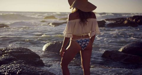 Serene Beach Sunset with Woman in Straw Hat