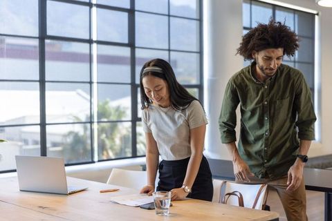 Diverse Coworking Team Reviewing Documents in Modern Office