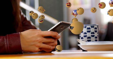Woman Engaging Holographic Emojis on Smartphone in Cafe - Download Free Stock Images Pikwizard.com