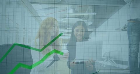 Two colleagues collaborating with overlay of business chart data