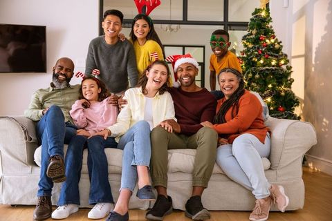 Diverse Family Smiling for Holiday Celebration with Christmas Tree
