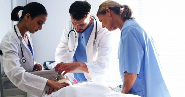 Medical team performing CPR on a patient in the intensive care unit, demonstrating emergency response and teamwork. Useful for articles, blogs, and educational materials about healthcare, emergency medical procedures, and the importance of teamwork in critical care settings.