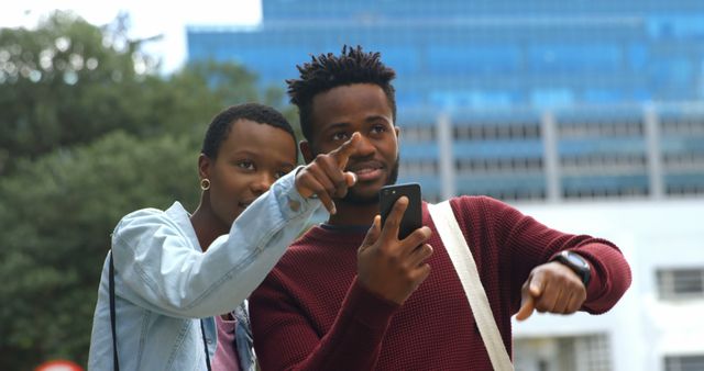 Young Friends Exploring City with Smartphone, Pointing towards Landmark - Download Free Stock Images Pikwizard.com