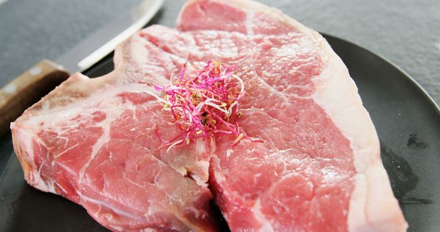 Raw Pork Chop on Black Plate With Sprouts - Download Free Stock Images Pikwizard.com