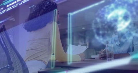 High-tech interview woman holding papers leaning toward colleague with holographic overlay