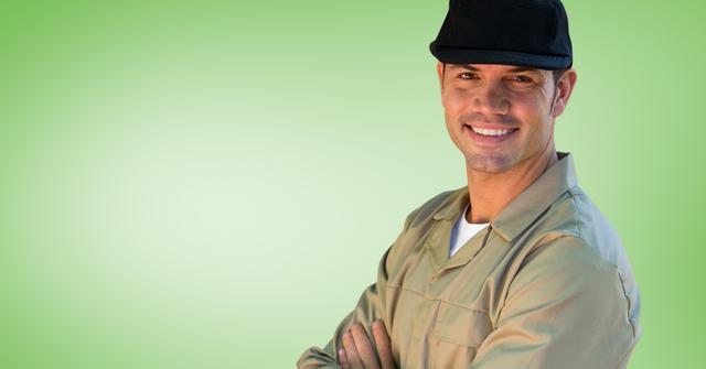 Portrait of smiling delivery man in cap against color background