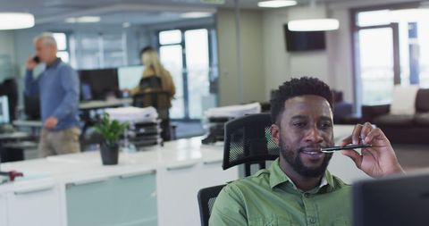 Businessman Contemplating Work in Modern Office Environment