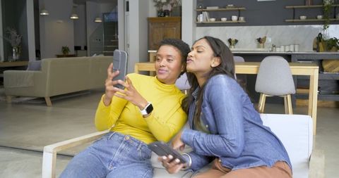 Two Female Friends Taking Selfie in Modern Loft Interior
