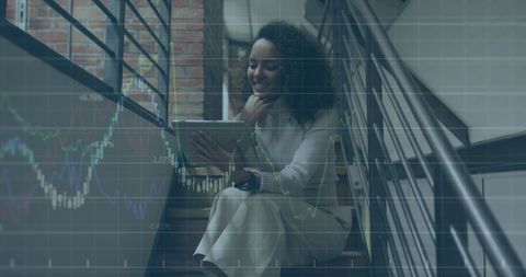 Businesswoman Analyzing Financial Data on Tablet in Modern Setting - Download Free Stock Images Pikwizard.com
