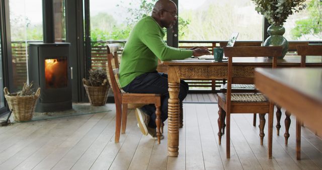 Man Working on Laptop in Cozy Home Office with Fireplace - Download Free Stock Images Pikwizard.com