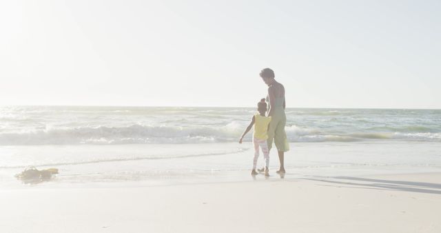 Mother and Daughter Walking on Sunny Beach - Download Free Stock Images Pikwizard.com