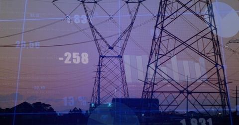 Silhouetted High-Voltage Transmission Towers at Dusk with Data Overlay and Energy Analytics