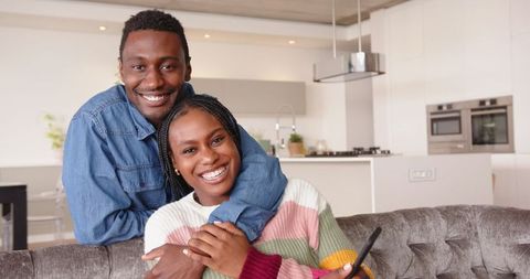 Cheerful Couple Relaxing Together in Modern Home Living Room