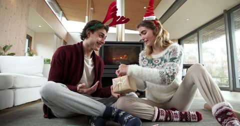 Christmas Gift Exchange by Cozy Fireplace at Home