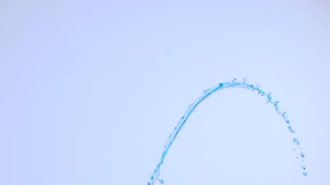 Blue Water Splash in Slow Motion Against Light Background