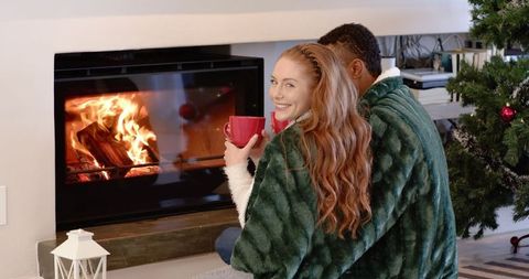 Cozy Couple by Fireplace During Winter Holiday Season