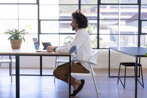 Professional Workspace with Laptop and Tablet Near Bright Window
