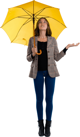 Woman holding yellow umbrella looking up transparent background