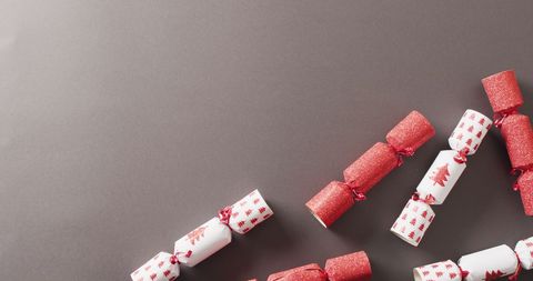 Festive christmas crackers on grey background with copy space