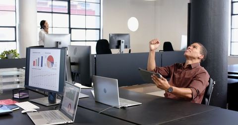 Excited Entrepreneur Celebrating in Modern Office
