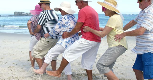 A group of happy senior friends dancing in a conga line on a beautiful sandy beach, demonstrating a joyful and carefree vacation. Perfect for promoting senior travel packages, retirement communities, active lifestyles in older age, and beach holiday destinations.