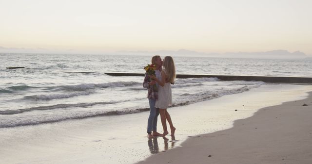 Romantic Couple Embracing on Sandy Beach at Sunset - Download Free Stock Images Pikwizard.com