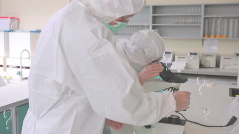 Scientists in Protective Gear Analyzing Samples under Microscope
